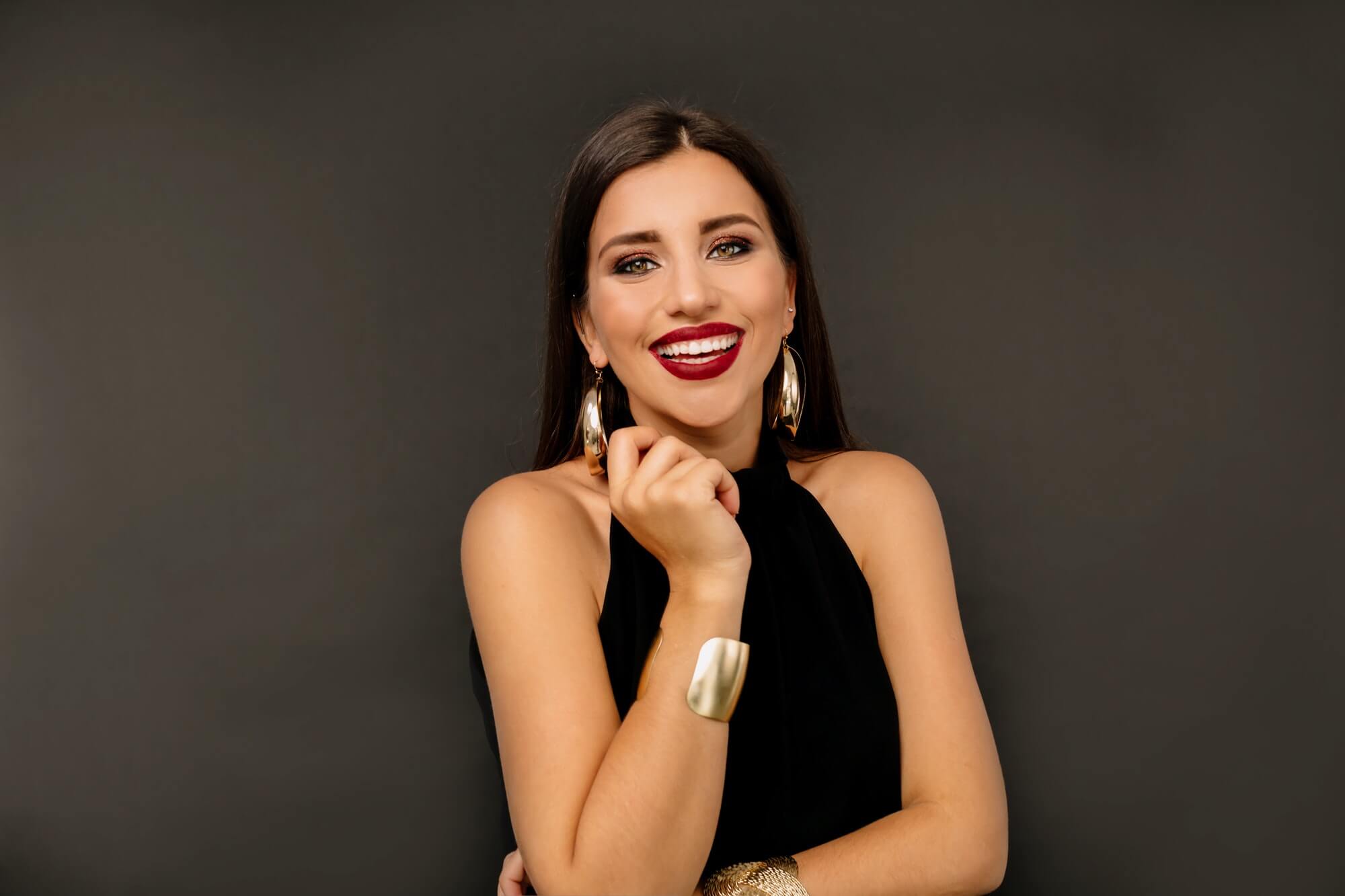 portrait-of-a-cheerful-beautiful-girl-wearing-black-dress-and-gold-earning-1.jpg